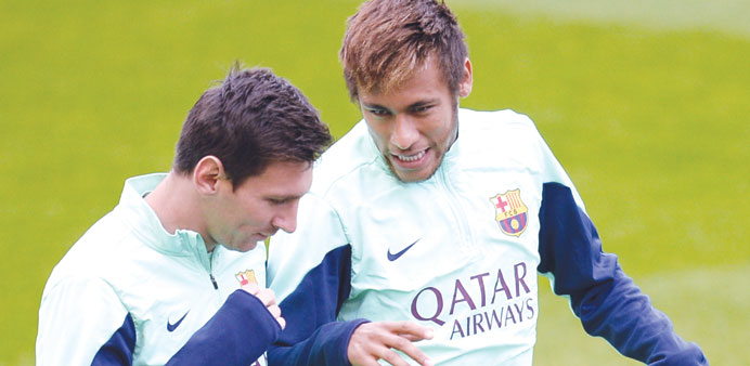 Barcelonau2019s Argentinian forward Lionel Messi (left) talks with Brazilian forward Neymar da Silva Santos Junior during a training session at the Mini S