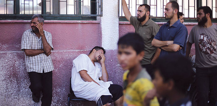 A Palestinian man mourning the death of his relative, killed in an Israeli air strike, outside a hospital morgue in Khan Younis in the southern Gaza S