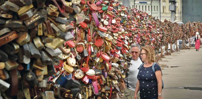 A couple locks a padlock on the u2018Pont des Artsu2019 in Paris.