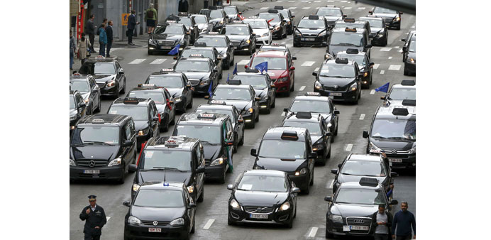 Taxi drivers from all over Europe line a street during a protest against Uber in central Brussels yesterday.