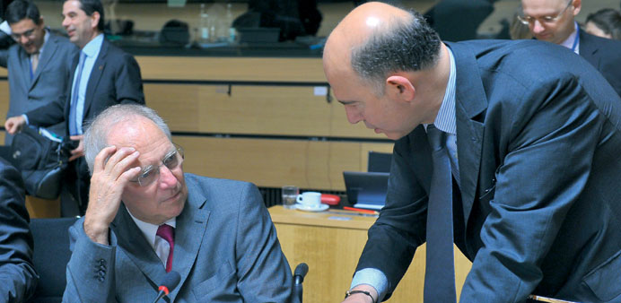 Schaeuble (left) chats with Moscovici at the EU Ecofin Council meeting at the EU headquarters in Luxembourg, on Friday night.
