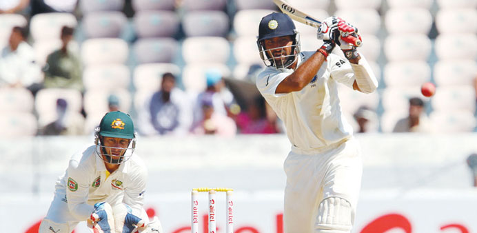 Indiau2019s Cheteshwar Pujara plays a drive on day two of the second Test against Australia in Hyderabad, India, yesterday; (below) Murali Vijay.