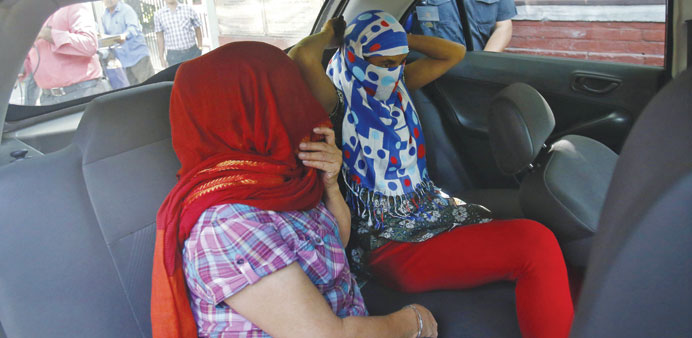 Two veiled Nepali women, who told police they were raped by a diplomat, sit in a vehicle outside Nepalu2019s embassy in New Delhi yesterday.