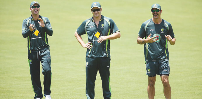 Australia captain Michael Clarke (left), all-rounder Shane Watson (centre) and fast bowler Mitchell Johnson share a laugh during training at the Adela