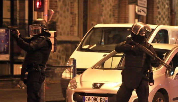 Police officers take up positions in Saint Denis, Paris, one of the locations of the attack, November 18, 2015