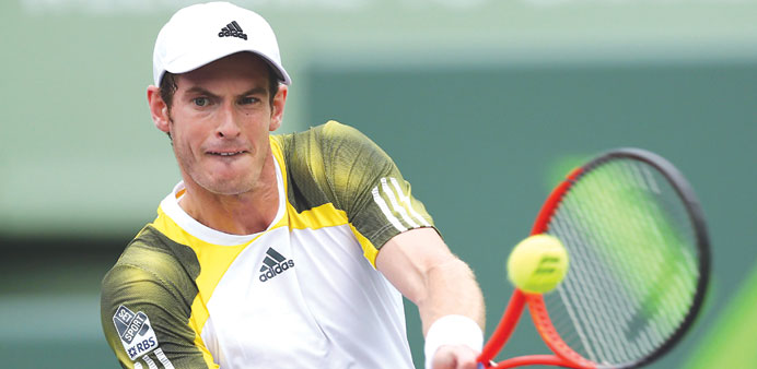 Andy Murray of Great Britain plays a backhand against Grigor Dimitrov of Bulgaria during their third round match at the Sony Open at Crandon Park Tenn