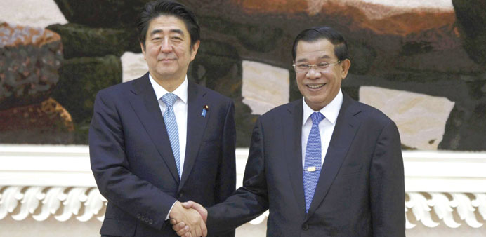 Japanu2019s Prime Minister Shinzo Abe shakes hands with Cambodiau2019s Prime Minister Hun Sen before a meeting at the Council of Ministers in central Phnom Pe