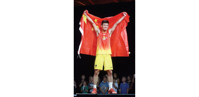 Chen Long of China celebrates at the podium after winning the mens single final against Lee Chong Wei from Malaysia at the 2014 BWF World Badminton ch