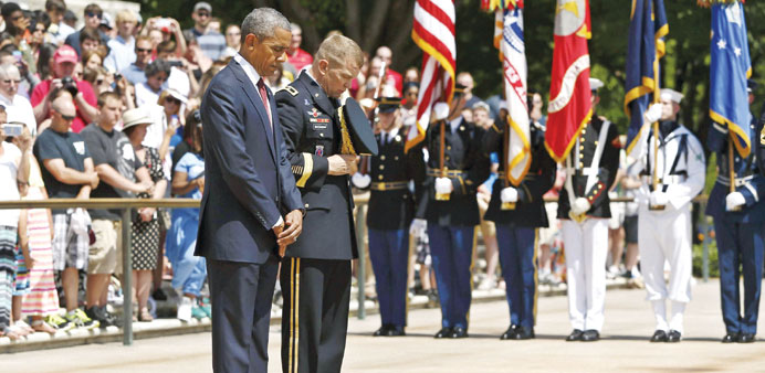 President Barack Obama and US Army Military District of Washington Commanding General Jeffrey Buchanan participate in the wreath-laying ceremony at th