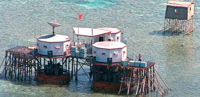 The Chinese national flag flies above octagonal structures built on stilts in the Manila-claimed Mischief Reef in the disputed Spratly Islands located