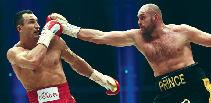Fury  (right) throws  punch as Klitschko defends last Saturday.