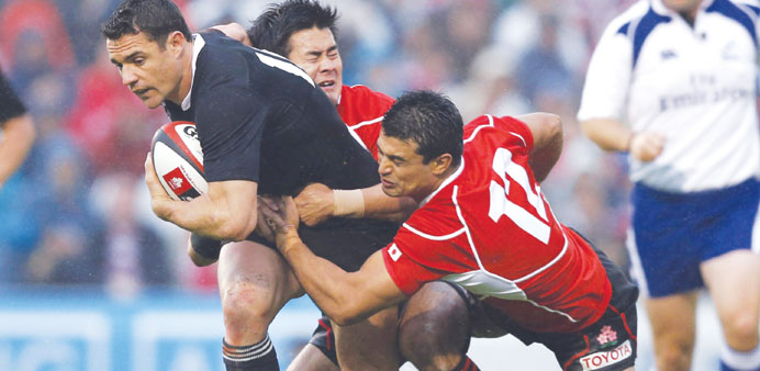 New Zealand All Blacks Daniel Carter (left) is tackled by Japanu2019s Craig Wing (right) and Yuu Tamura during their international rugby Test match in Tok