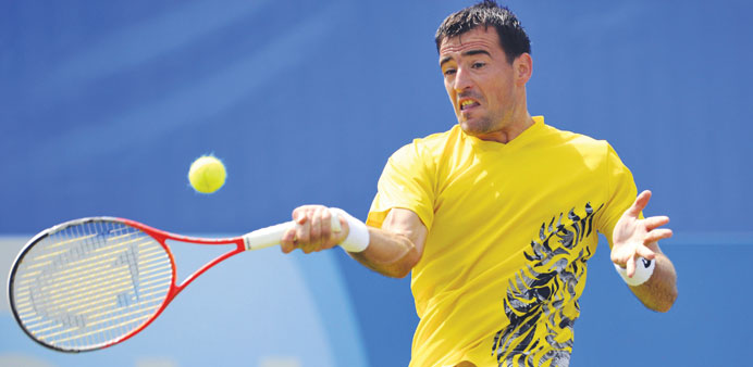 Croatiau2019s Ivan Dodig returns to Canadau2019s Milos Raonic during their AEGON International pre-quarter-final match in Eastbourne yesterday. (AFP)