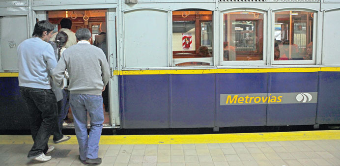 * Riders board a Buenos Aires mass-transit train.