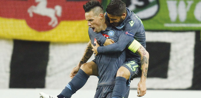 Napoliu2019s Marek Hamsik (left) celebrates his goal against Wolfsburg.