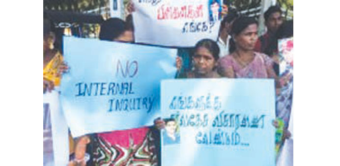 Protesters holding placards gainst a proposed domestic probe into human rights abuses during the countryu2019s civil war, Jaffna yesterday.