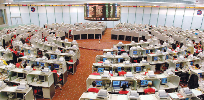 Traders at the Hong Kong Stock Exchange. Hong Kong shares rose 0.28% or 67.65 points to close at 24,600.08 yesterday.
