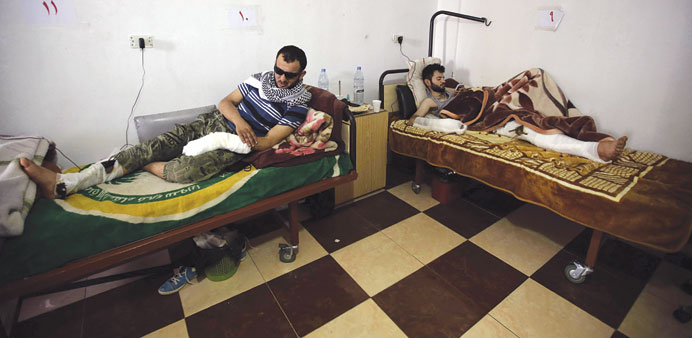 Injured Syrians rest at a field hospital in the Lebanese border town of Arsal.