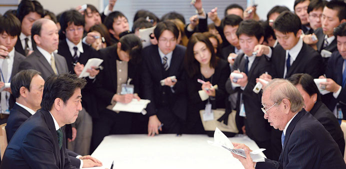 Japanese Prime Minister Shinzo Abe, (left, foreground) and Okinawa governor Hirokazu Nakaima (right, foreground) talk during their meeting at Abeu2019s of
