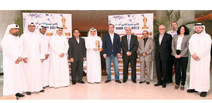 Senior Ooredoo executives with the HH the Emir Cup trophy.