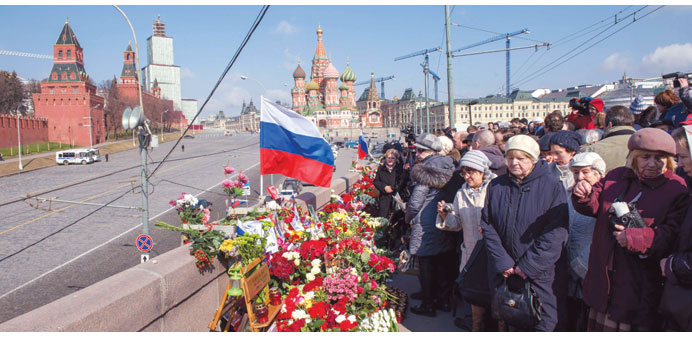  Mourners gather at the site where Russian opposition leader Boris Nemtsov was shot dead, near Saint-Basilu2019s Cathedral in central Moscow, to mark 40 d