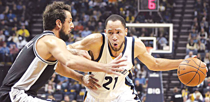 Memphis Grizzliesu2019 Tayshaun Prince dribbles the ball past San Antonio Spursu2019 Marc Belinelli, of Italy in the first half of an NBA basketball game in M