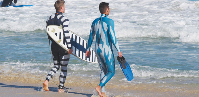 A Shark Attack Mitigation Systems (SAMS) handout photo received yesterday of a surfer (left) and a diver wearing wetsuits displaying the two styles of