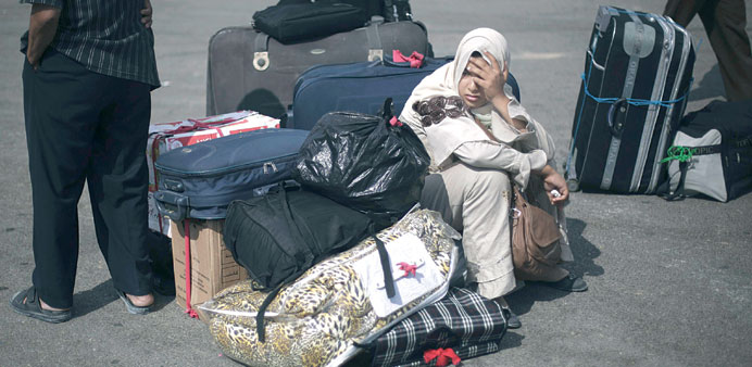 Palestinians wait to cross into Egypt at Rafah border crossing yesterday.