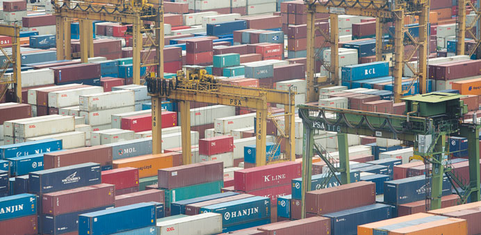 Cranes and shipping containers sit at the Port of Singapore. Prime Minister Lee Hsien Loong said yesterday the  economy exceeded forecasts to expand 3