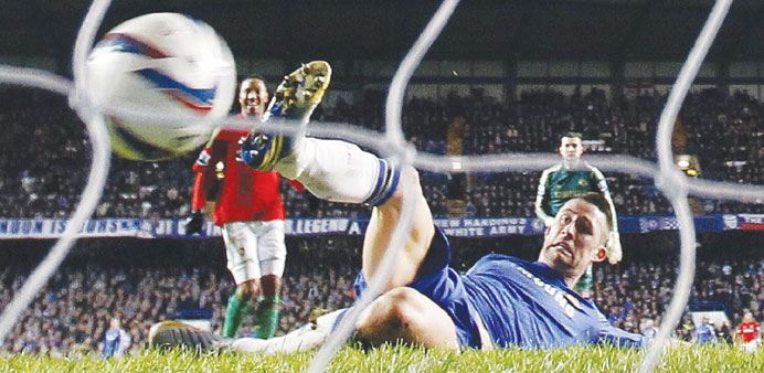 Swansea Cityu2019s Danny Graham (not pictured) scores past Chelseau2019s Gary Cahill (front) during their English League Cup semi-final match at Stamford Brid
