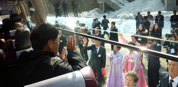 South Koreans aboard a bus waving goodbye to their North Korean relatives in 2014.