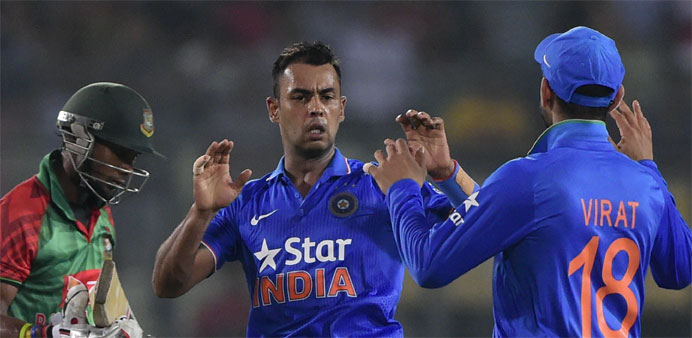 Indian cricketer Stuart Binny (C) celebrates with teammates after the dismissal of Bangladesh cricketer Sabbir Rahman (L) during the third ODI