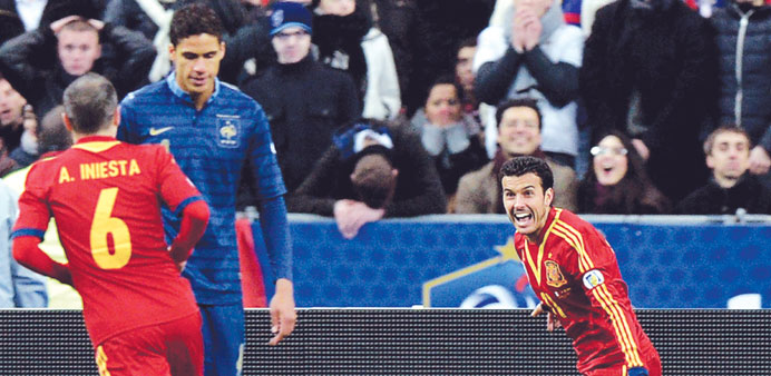 Spainu2019s Pedro (right) celebrates after scoring a goal against France in their World Cup 2014 qualifier match in Saint-Denis, outside Paris, on Tuesday