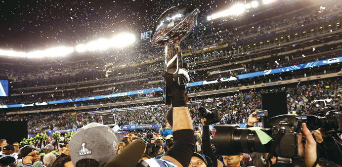 A Seattle Seahawks player holds aloft the Vince Lombardi Trophy after winning the Super Bowl XLVIII on Sunday.  (EPA)