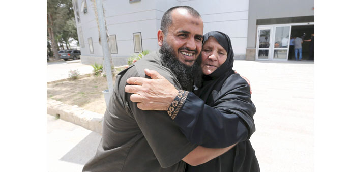A man hugs his mother after she returned to Gaza through the Rafah border crossing yesterday.