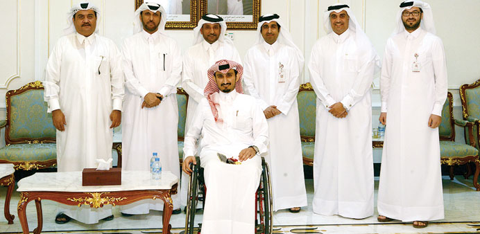 Al-Sharqi, third right, with members of the voluntary committee for employing the disabled at QC headquarters. 