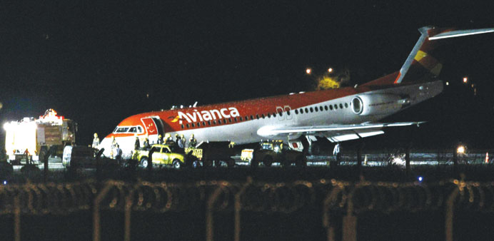 An Avianca Brazil Fokker 100 aircraft is surrounded by rescue personnel after an emergency landing at Juscelino Kubitschek airport in Brasilia.