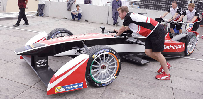 Engineers move a Mahindra Racing car on the eve of the Formula E Championship race in Beijing today. (Reuters)
