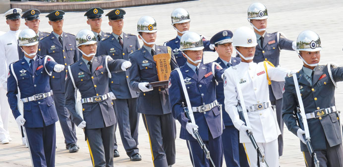 An honour guard holds a soldiersu2019 tablet during a ceremony to honour the dead soldiers of Taiwan killed in Myanmar during World War II, at the Martyru2019