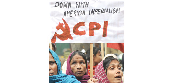Activists from the Communist Party of India hold placards during a protest near the American Centre in New Delhi yesterday.