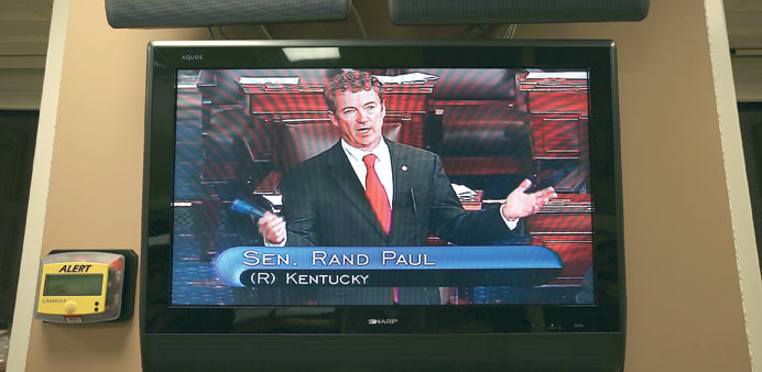 Paul is seen on a TV monitor as he participates in the filibuster.