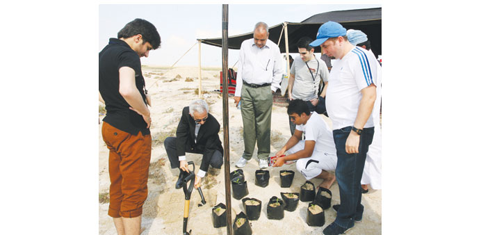 Professors Dr Khan and Dr Jaoua demonstrate to students how to correctly plant the seeds.