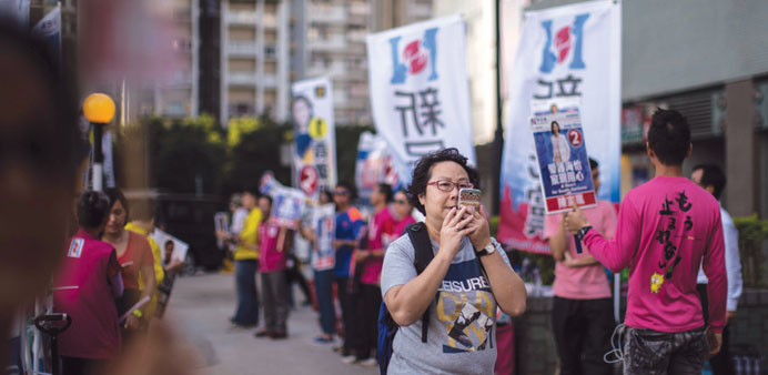 Campaigners near a polling station in the Southern district of Hong Kong.