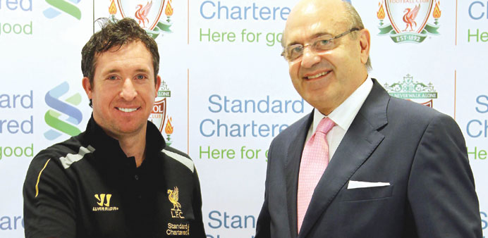 Liverpool legend Robbie Fowler (left) with Standard Chartered Bank CEO Charles Carlson at the Oryx Rotana Hotel yesterday.