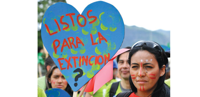  A woman holds a sign reading u2018Are you ready for extinctionu2019 during the Global Climate March in Bogota on Sunday.