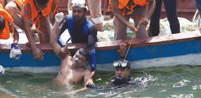 Divers recovering a body from the sunken ferry MV Miraj 4 in the Megna river near Munshiganj, 50km southeast of the capital Dhaka, yesterday.