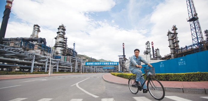 A worker cycles through the China Petroleum & Chemical Corp. (Sinopec) Yanshan refinery in Beijing (file). Chinau2019s total imports from Iran averaged ab