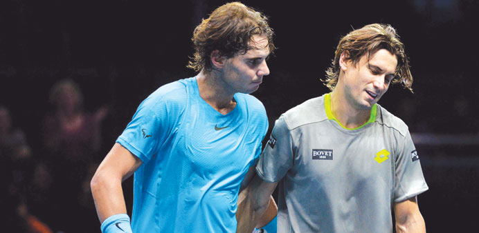 WELL PLAYED: Spain's Rafael Nadal (left) consoles compatriot David Ferrer after their Group A clash at the ATP World Tour Finals in London yesterday. 