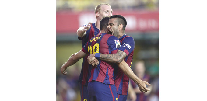 Barcelonau2019s forward Sandro is congratulated by his teammate Dani Alves (right) after scoring during the La Liga match against Villarreal at the Camp E