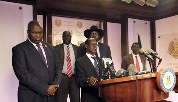 South Sudan Second Vice President James Wani Igga (centre), flanked by South Sudan President Salva Kiir (right) and First Vice President Riek Machar (left), addresses a news conference at the Presidential State House in Juba.